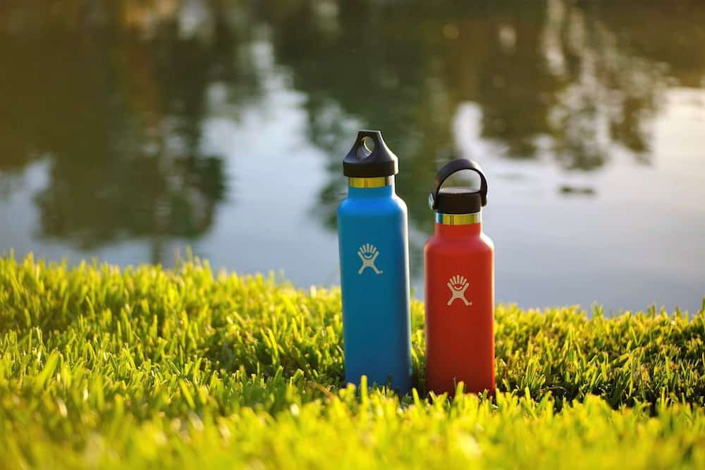 Water bottles sitting in grass.