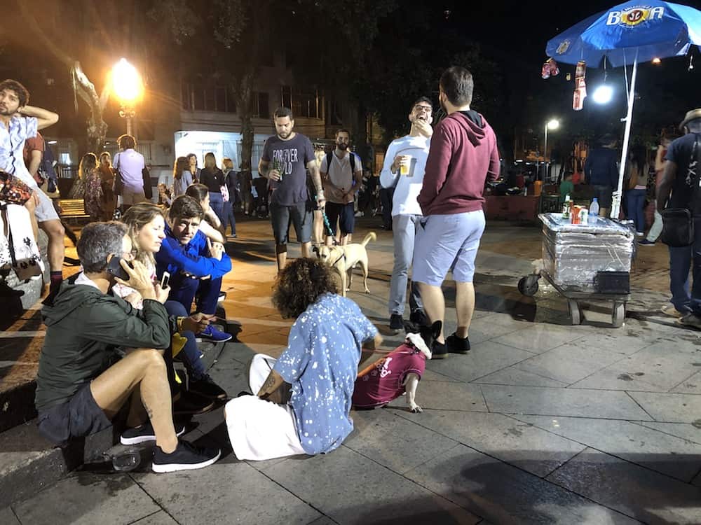 A crowd of people hang out in a plaza in Rio de Janeiro.