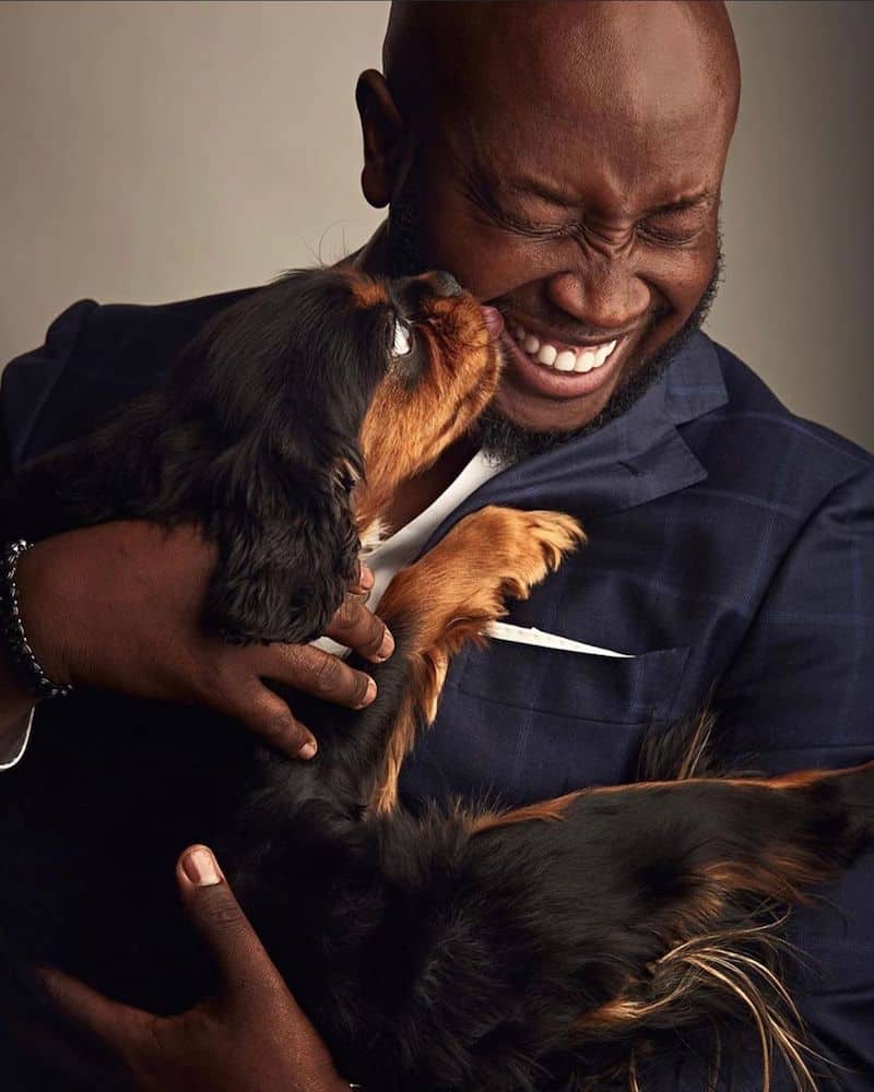 The Dog Father of Harlem gets licked by a dog. 